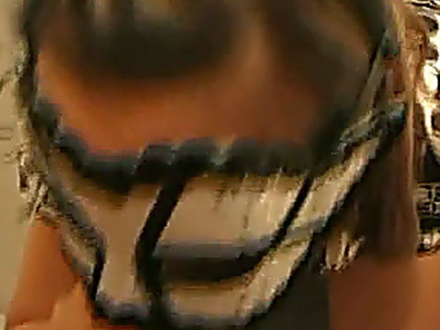 Masked slut sucks cock in a glory hole