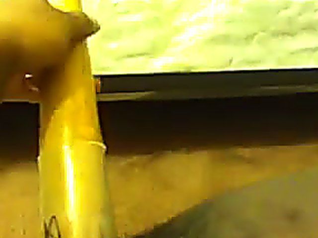 Ebony babe plays with her yellow toy