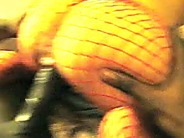 White woman in red fishnets rides big black pole