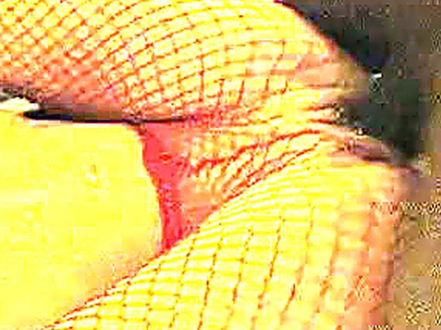 White woman in red fishnets rides big black pole