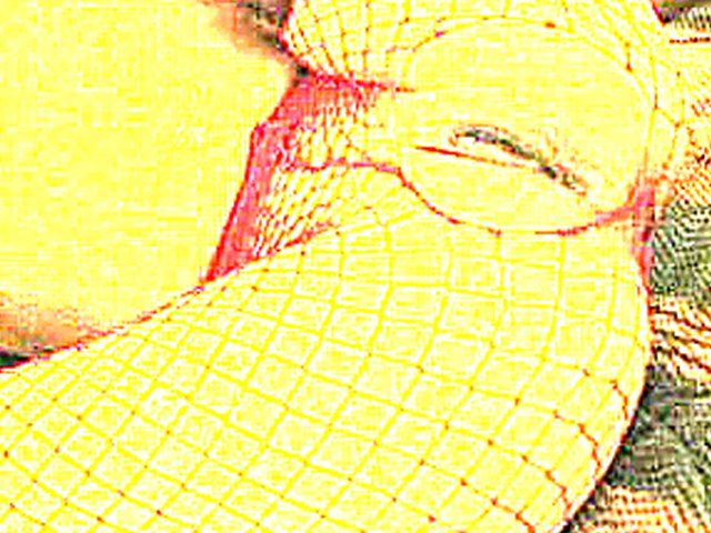 White woman in red fishnets rides big black pole