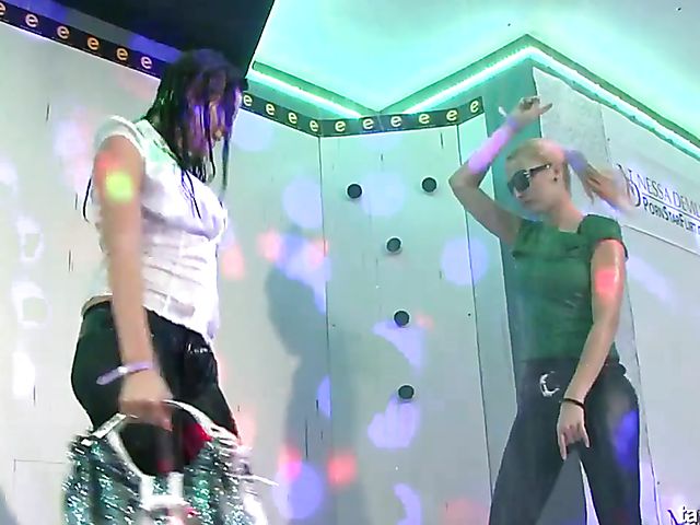 Clothed ladies get wet and strip nude in the club