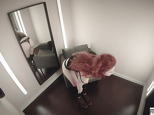 Redhead Heidi Rom plays with her pink pussy in the fitting room