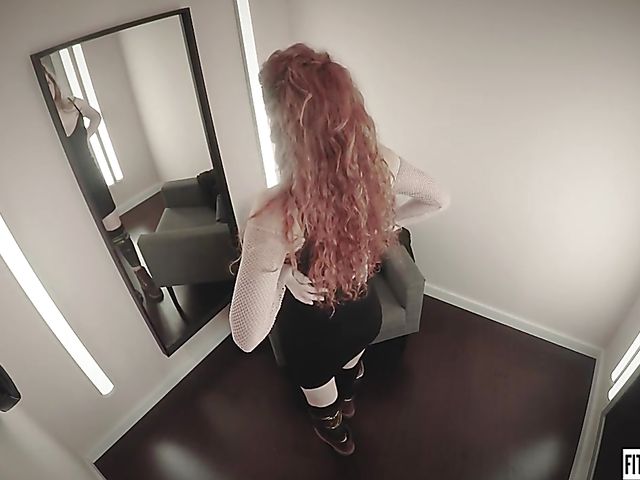 Redhead Heidi Rom plays with her pink pussy in the fitting room