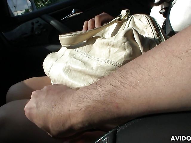 Japanese sweetie Karin Asahi gives a car blowjob 