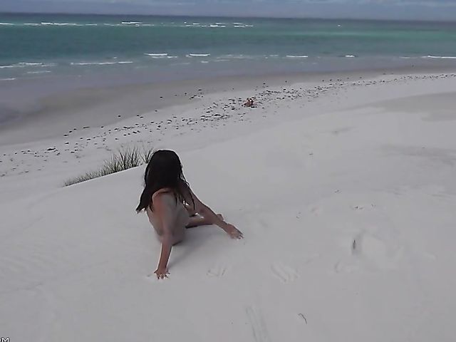 Jasmine Summers posing nude in sand by the ocean  