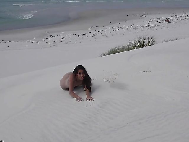 Jasmine Summers posing nude in sand by the ocean  