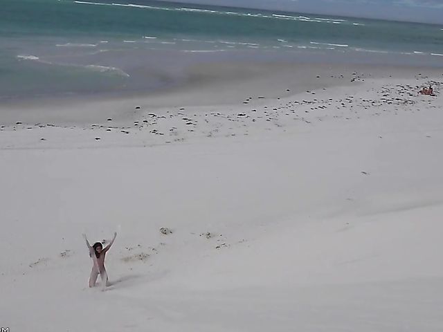 Jasmine Summers posing nude in sand by the ocean  