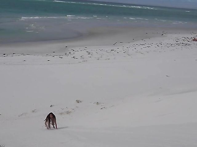 Jasmine Summers posing nude in sand by the ocean  