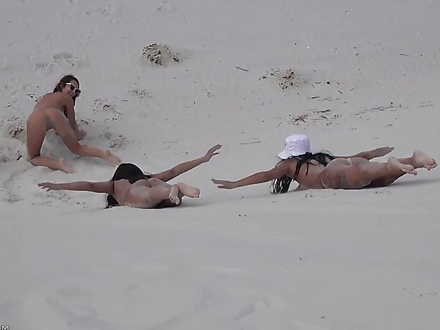 Four sexy nude girls play in the dunes 