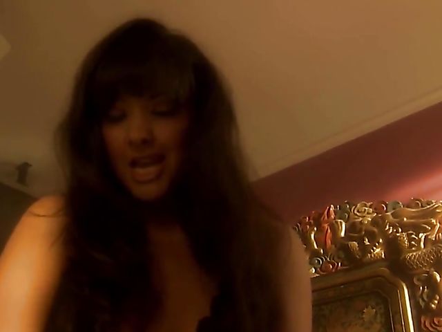 Carmen Hart in black boots and lingerie rides a cock in bed