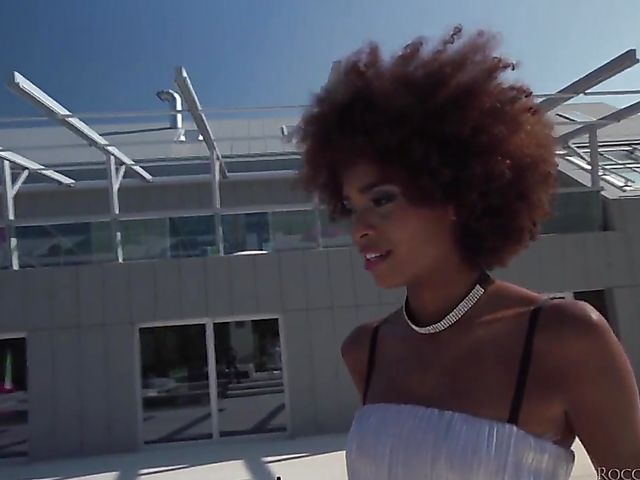 Ebony babe Luna Corazon shares a white pole with fishnet girl Kiki Cyrus 