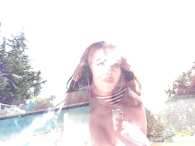 Busty bikini model Cara Rose posing by the pool