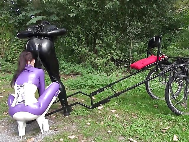 Human pony training outdoors with Mistress Susi's rubber slave