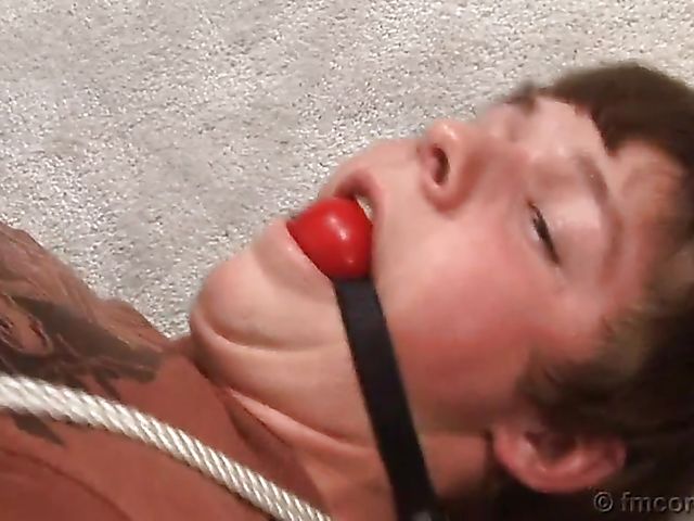 Guy tied up and ball gagged by his leggy mistress in a mini skirt