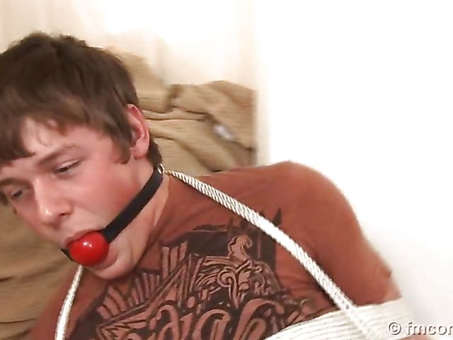 Guy tied up and ball gagged by his leggy mistress in a mini skirt