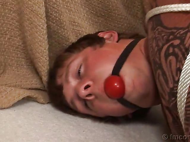 Guy tied up and ball gagged by his leggy mistress in a mini skirt