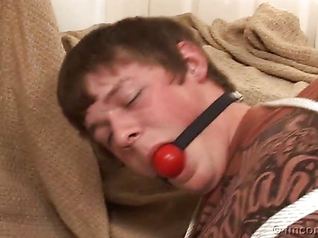 Guy tied up and ball gagged by his leggy mistress in a mini skirt