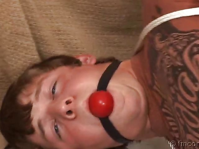 Guy tied up and ball gagged by his leggy mistress in a mini skirt