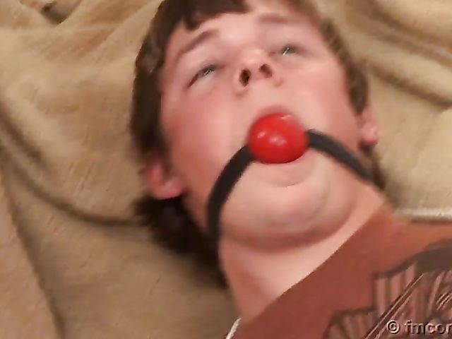 Guy tied up and ball gagged by his leggy mistress in a mini skirt