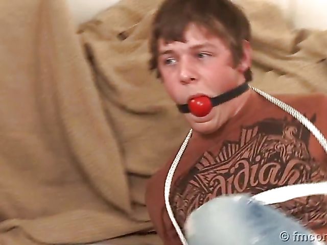 Guy tied up and ball gagged by his leggy mistress in a mini skirt