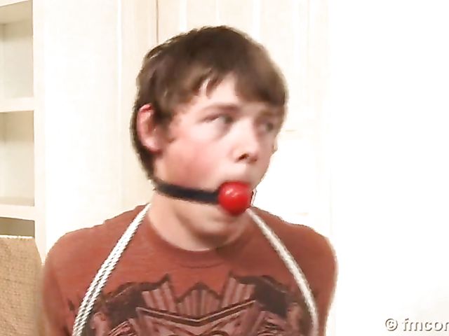 Guy tied up and ball gagged by his leggy mistress in a mini skirt