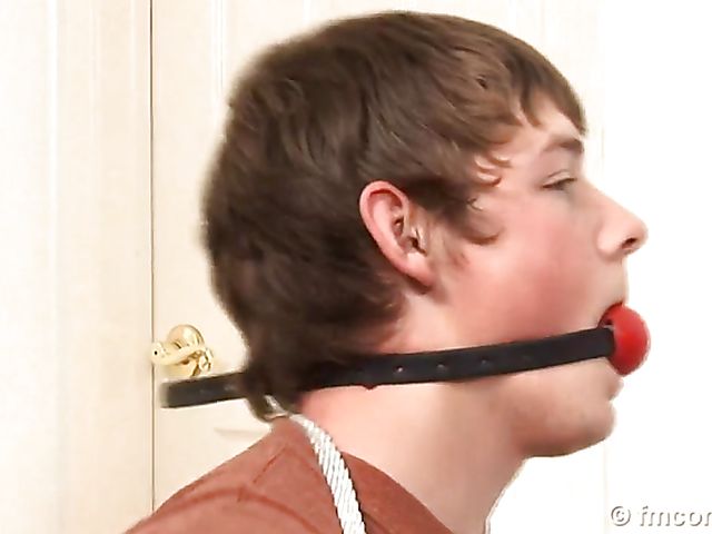 Guy tied up and ball gagged by his leggy mistress in a mini skirt