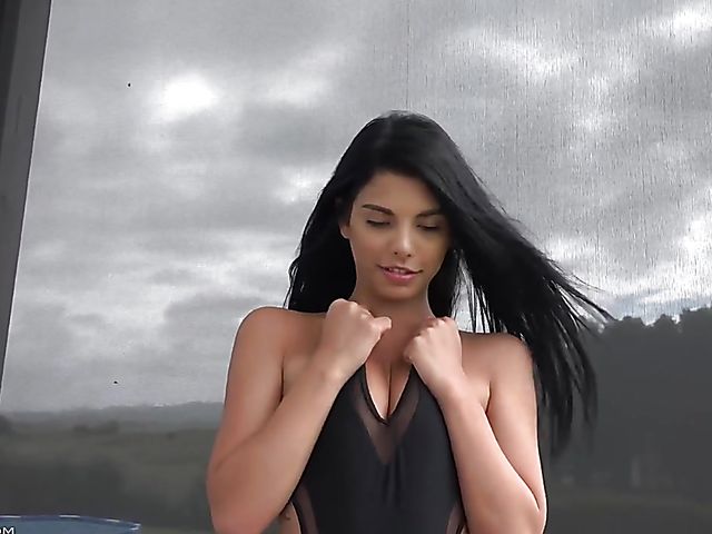 Pretty latina Gina Valentina solo posing in black bodysuit  and boots