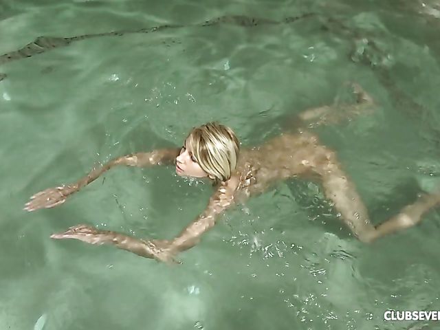 Teen Missy Luv swimming naked in the pool and fingering