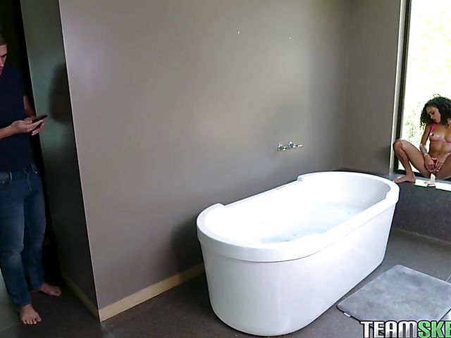 Curly-haired petite ebony teen Scarlit Scandal flaunts her ass in the bath and gets caught by a white guy