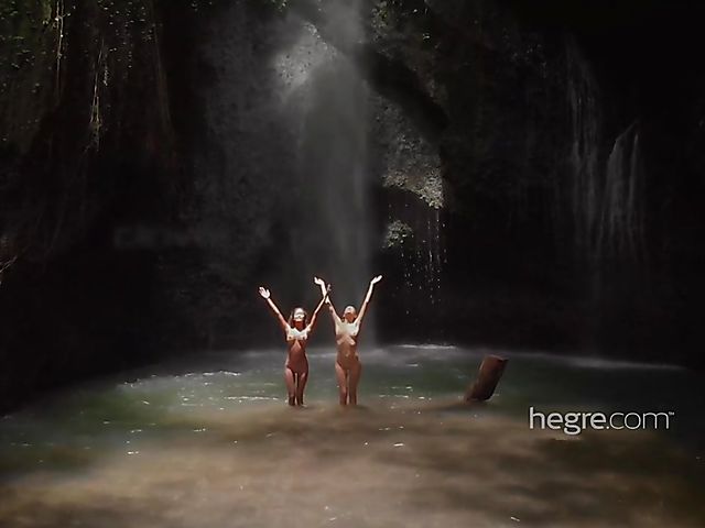 Nude girls Clover and Putri get wet under the waterfall in Bali