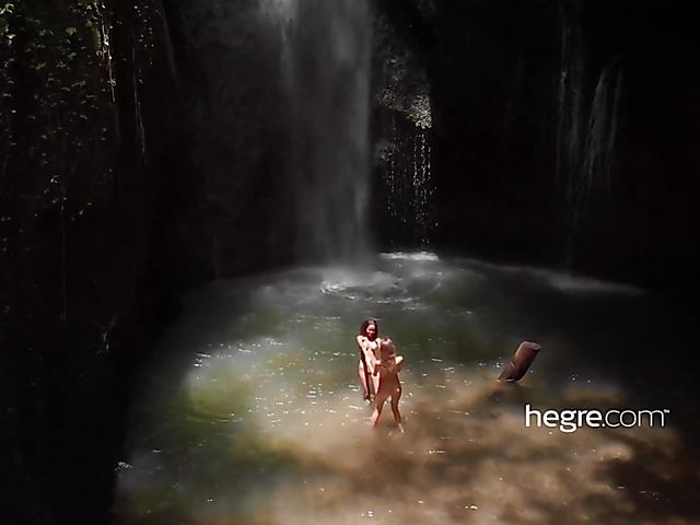 Nude girls Clover and Putri get wet under the waterfall in Bali