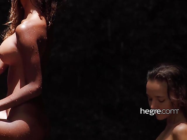 Nude girls Clover and Putri get wet under the waterfall in Bali