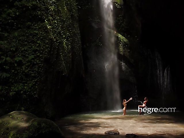 Nude girls Clover and Putri get wet under the waterfall in Bali