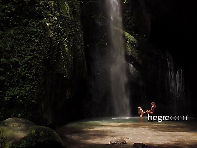 Nude girls Clover and Putri get wet under the waterfall in Bali