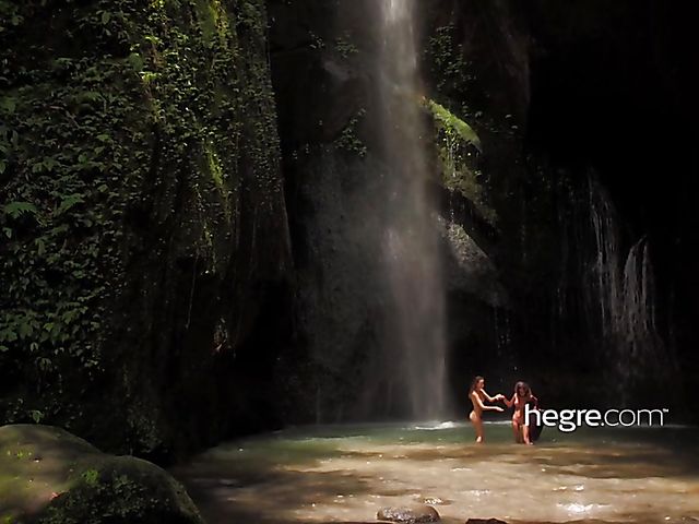 Nude girls Clover and Putri get wet under the waterfall in Bali