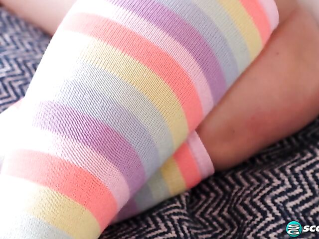Young solo in rainbow socks on the bed with Aria Banks