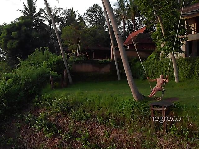 Nude art shoot backstage with Clover swinging outdoors in Bali