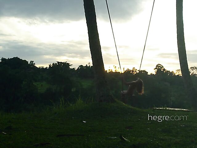 Nude art shoot backstage with Clover swinging outdoors in Bali