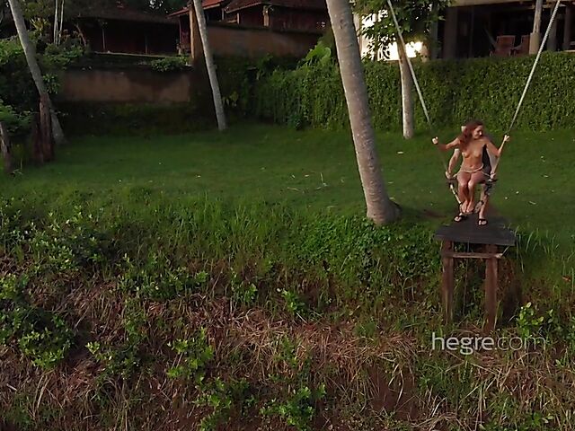 Nude art shoot backstage with Clover swinging outdoors in Bali