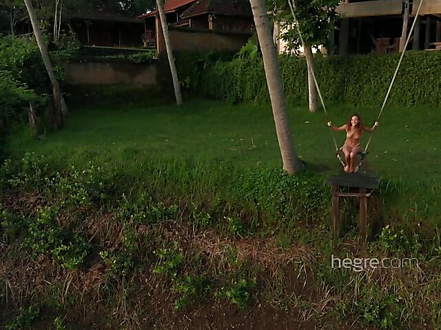 Nude art shoot backstage with Clover swinging outdoors in Bali