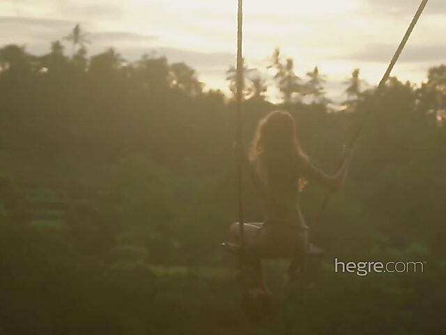 Nude art shoot backstage with Clover swinging outdoors in Bali