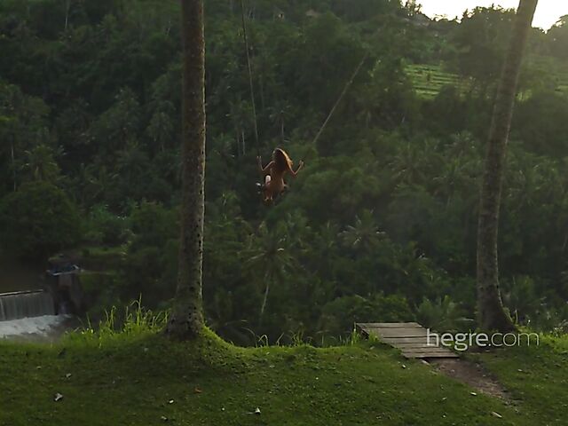 Nude art shoot backstage with Clover swinging outdoors in Bali
