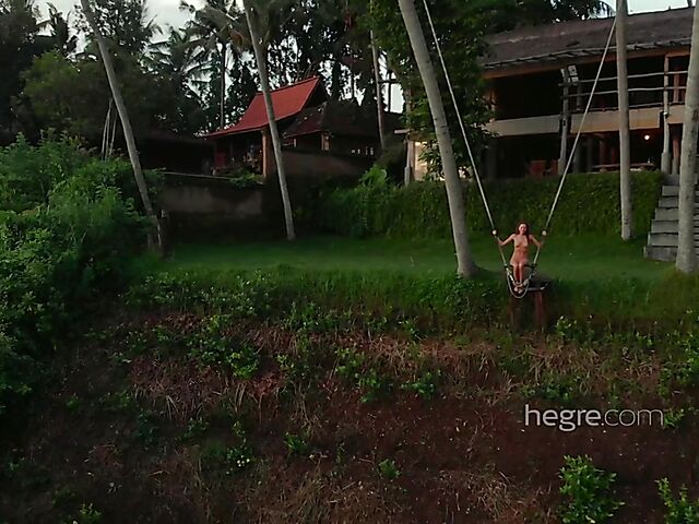 Nude art shoot backstage with Clover swinging outdoors in Bali