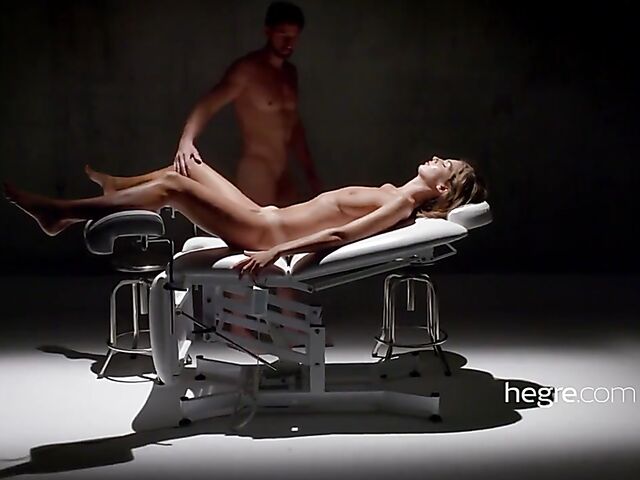 Erotic massage with legs wide open on a gyno chair