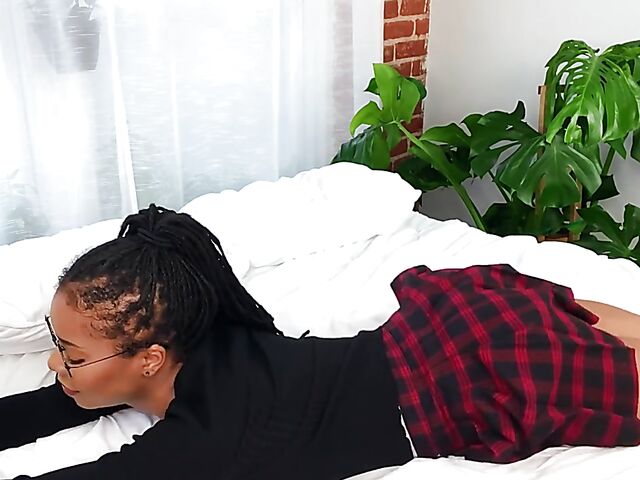 Nerdy ebony schoolgirl Kira Noir masturbates in her bed