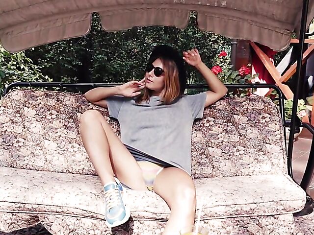 Met Art model with sunglasses Belka stripping and smoking in the garden