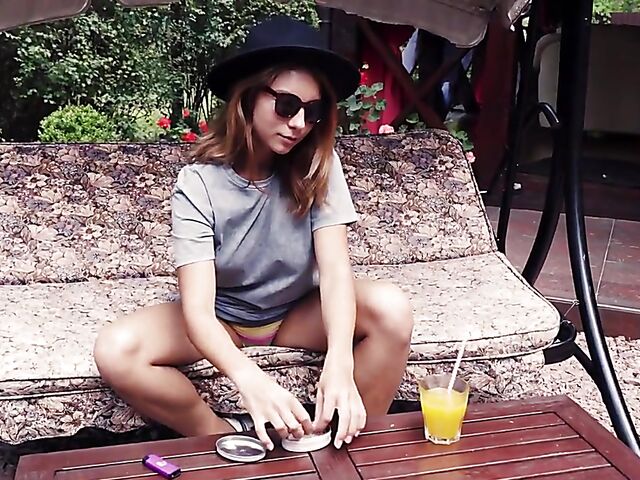 Met Art model with sunglasses Belka stripping and smoking in the garden