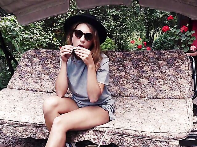 Met Art model with sunglasses Belka stripping and smoking in the garden