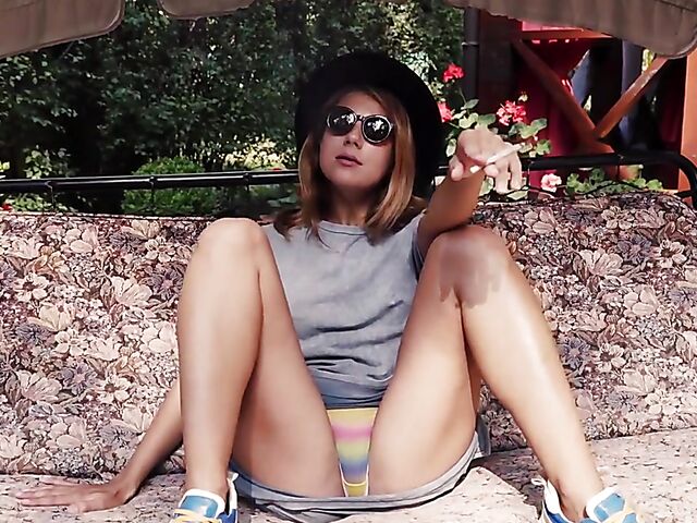 Met Art model with sunglasses Belka stripping and smoking in the garden